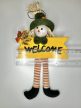 Hosszú lábú kópé: madárijesztős Welcome őszi ajtófüggő